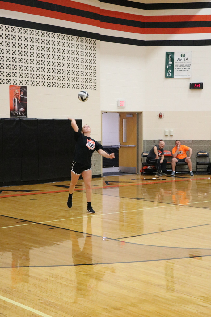 Student serving volleyball